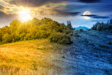 mountain landscape with foliage forest on autumn equinox. day and night time change concept. beautiful beech woodland on rolling hills in highland with sun and moon. duality and transition template