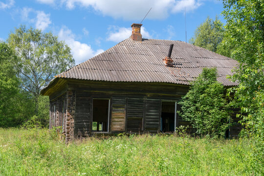 Ruins of an old abandoned wooden house in the countryside