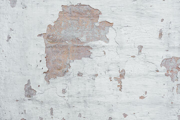 Peeling white paint on concrete surface showing rough texture detail