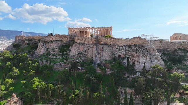 Aerial drone cinematic video of iconic Acropolis hill and the Parthenon featuring Erechtheion and Porch of the Caryatids, Athens historic centre, Attica, Greece