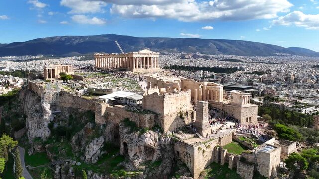 Aerial drone cinematic video of iconic Acropolis hill and the Parthenon featuring Erechtheion and Porch of the Caryatids, Athens historic centre, Attica, Greece