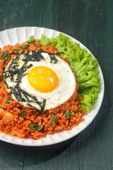 Kimchi bokkeumbap (kimchi fried rice) is a Korean dish consisting of rice fried with kimchi.