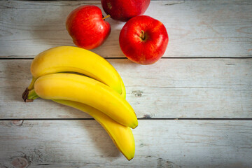 Apples and bananas on a wooden table