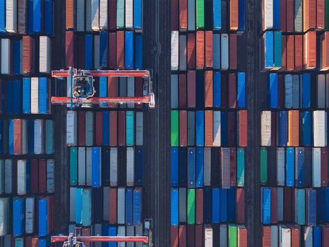 Aerial view of stacked shipping containers create a colorful mosaic of global commerce at the Port of Los Angeles, California, United States.