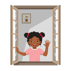 Little African girl opening window greeting waving hand in the morning