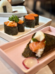 An incredibly delicious selection of sushi and rolls, a variety of fish, raw fish, avocado, wasabi, soy sauce, sesame seeds, chopsticks, Japanese food.