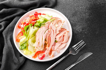 White bowl salad with cherry tomatoes, cheese, pepper and turkey for protein meal, diet food or fitness lifestyle concept