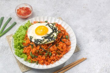 Kimchi bokkeumbap (kimchi fried rice) is a Korean dish consisting of rice fried with kimchi.