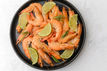 Shrimp and lime arranged in white plate for gourmet lunch or elegant seafood concept