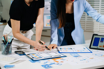 UX graphic designer planning application process development prototype wireframe for web smart phone. Creative digital development agency.