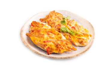 baked chicken meat with cheese and tomatoes isolated on white. side view, close up