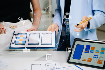 Close up view of UI developer team brainstorming on their project with laptop, smartphone and digital tablet. Creative digital development agency.