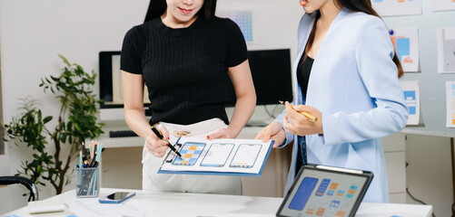 Close up view of UI developer team brainstorming on their project with laptop, smartphone and digital tablet. Creative digital development agency.