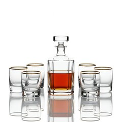 A decanter and glasses filled with whiskey on a wooden table with a decorative object beside it