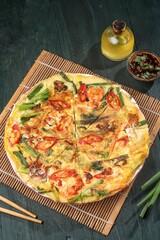 Pajeon is a typical Korean savory pancake made from flour dough, spring onions, and various seafood.