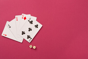 Poker chips and playing cards on color background, top view. Casino card game