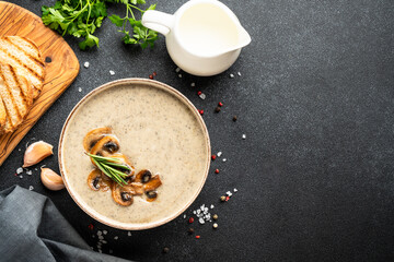 Mushroom soup puree on white kitchen table.
