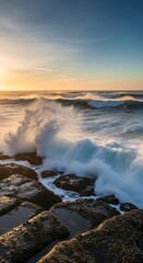Fototapeta premium Ocean waves crashing against rocks at sunset, beautiful seascape view.