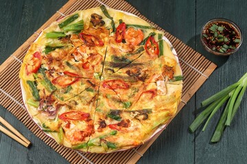 Pajeon is a typical Korean savory pancake made from flour dough, spring onions, and various seafood.