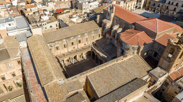 Aerial view of the internal courtyard of a historic building. It is located in Sciacca, in the province of Agrigento, Sicily, Italy. It's a beautiful, sunny summer day. - Powered by Adobe