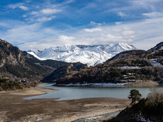 Obraz premium Lanuza Reservoir with snow-capped mountains in the background, in the Aragonese Pyrenees, Huesca, Spain