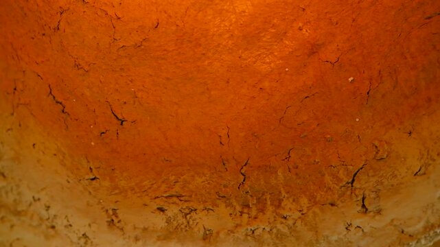 Rough texture background with cracks and warm gradient colors of orange and beige.