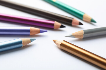 Fototapeta premium Colorful eye pencils on white background, closeup