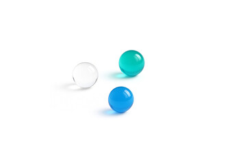 Minimalist composition featuring several glossy glass spheres  arranged on a pure white surface