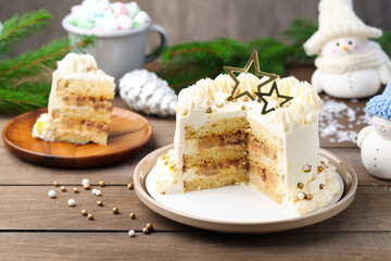 Delicious cake with Christmas decor and marshmallows on wooden table, closeup