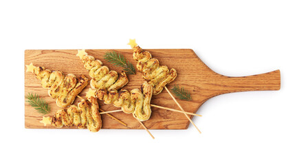 Christmas trees made with puff pastry, pesto sauce, cheese and fir branches on white background, top view
