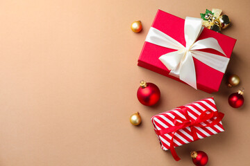 Gift boxes and Christmas decor on beige background, flat lay. Space for text