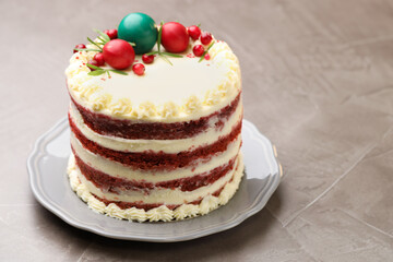 Delicious sponge cake with Christmas decor and red currants on grey textured table, closeup. Space for text