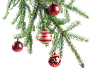 Christmas tree branch with ornaments isolated on white