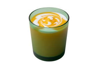 Vibrant yellow smoothie in a teal glass, showcasing a swirl of white cream on top against a black backdrop.