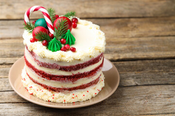 Tasty cake with Christmas decor on wooden table, closeup. Space for text