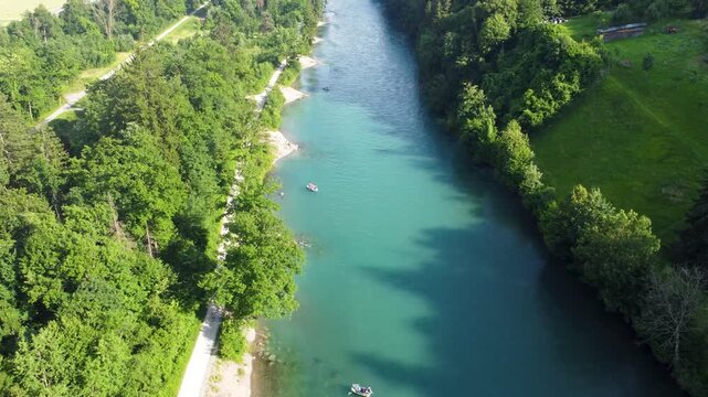 Drone footage of the Aar river in Switzerland, where people enjoy the transportation down in inflatables and swimming.