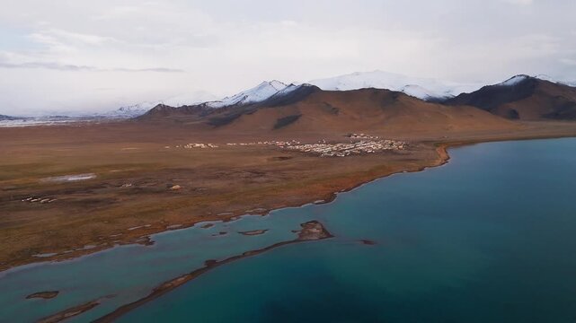 Aerial view of Karakul village on the shore of Lake Karakul, Pamir Mountains, Tajikistan travel destination adventure