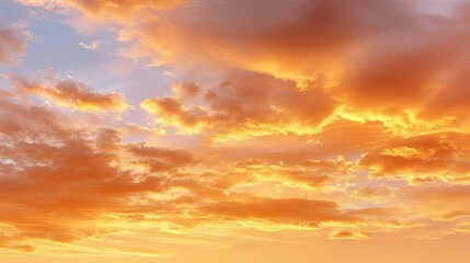 Fototapeta premium Stunning Evening Sky with Vibrant Orange and Yellow Clouds in a Blue Atmosphere During Sunset Over a Peaceful Horizon at Dusk