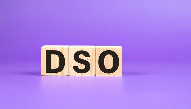 Three wooden cubes spelling "DSO" stand against a solid purple backdrop. The letters are black, bold and centered on the cubes