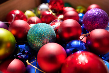 Pile of Christmas balls of different colors, sizes and textures. Objects for decoration to hang on the Christmas tree