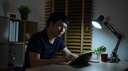 man using with digital tablet at a night - Powered by Adobe