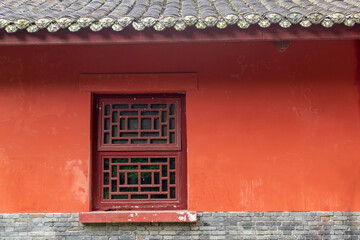 The traditional Chinese ancient-style building features red tiled houses