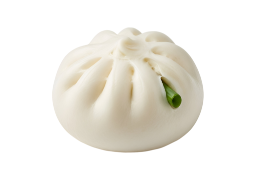 A delectable, steamed bun, showcased against a stark black background, features a sprig of fresh green herbs.
