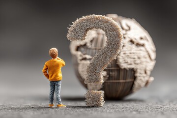 Person holds digital globe with a large question mark floating above their hands expressing need for answers