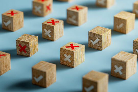 Wooden blocks scattered on a blue surface featuring red crosses and white check marks symbolizing approval and rejection concepts in decision making - Powered by Adobe