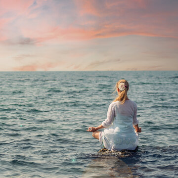 Woman meditating at the sea