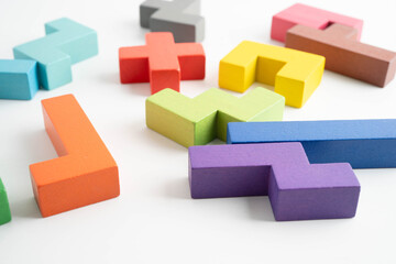 Obraz premium Logical thinking and problem solving problem solution creative business, wooden puzzle geometric block shape.