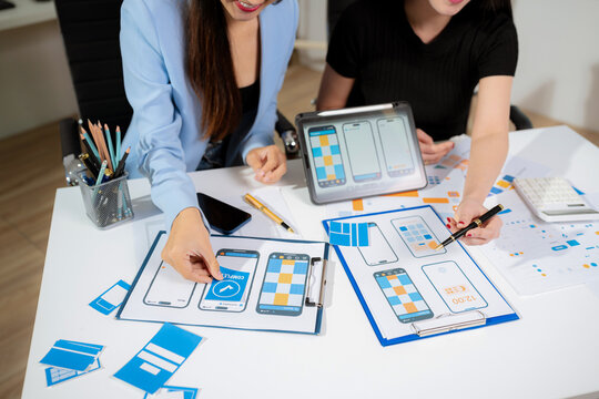 Creative digital development agency. developer team brainstorming on their project with laptop, smartphone and digital tablet.