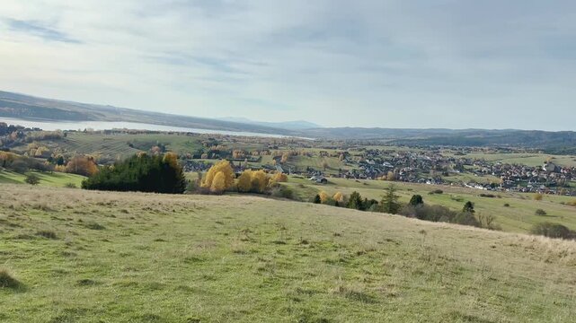 View of countryside with lake, sunny day