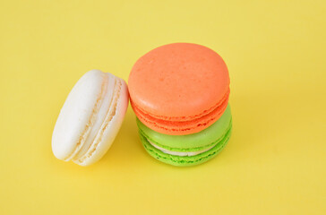 a close up of Colorful French Macarons on a Bright Yellow Background